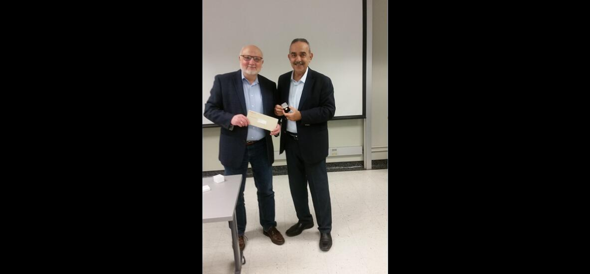 Prof Mitri receiving McGill's lapel pin for 30 years of service